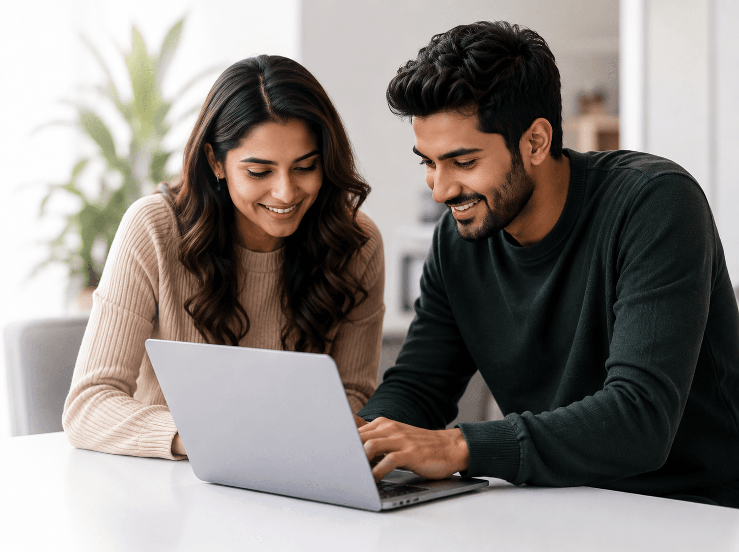 Two professionals collaborating on a laptop